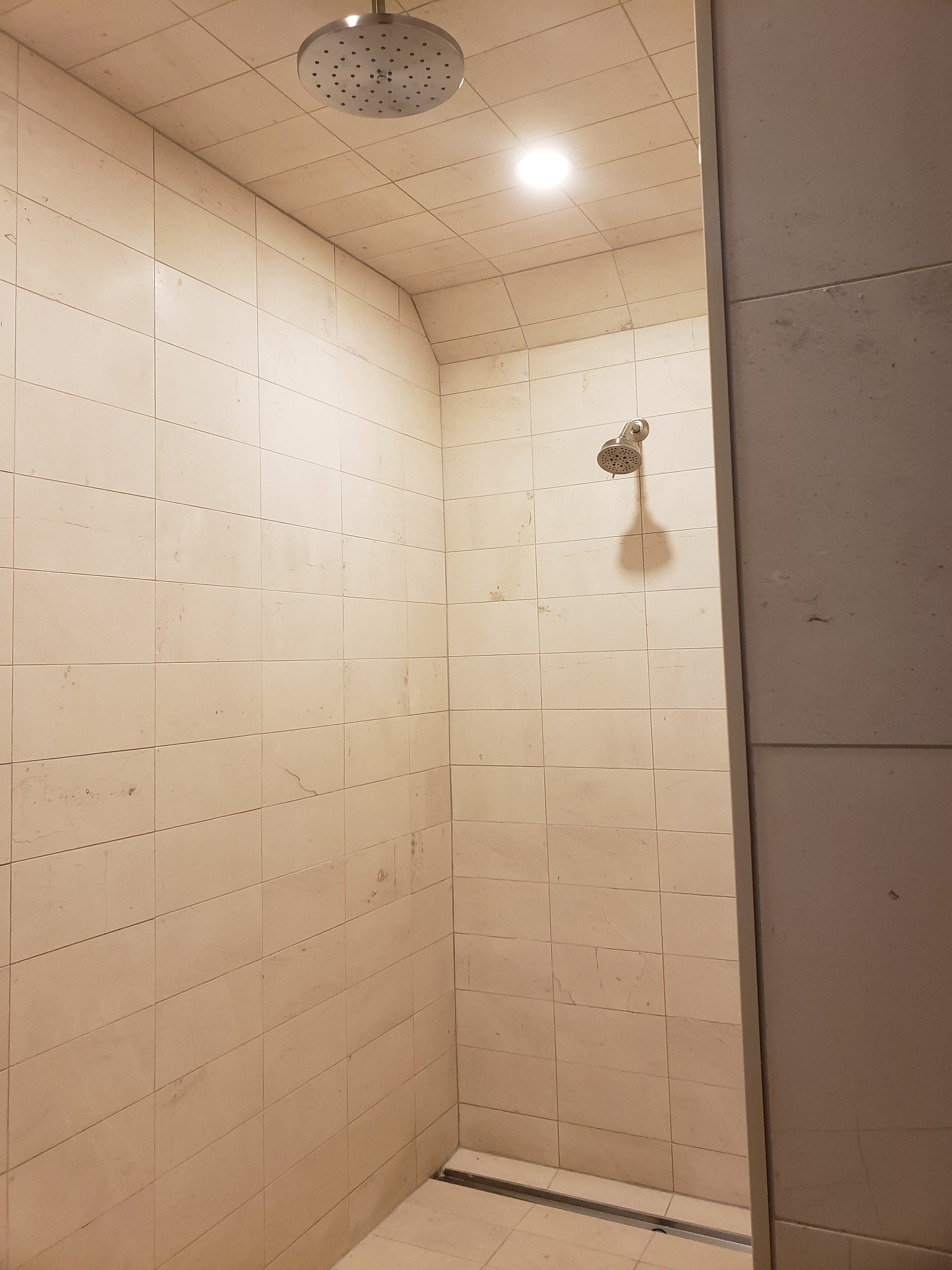 Professional bathroom remodel project featuring bathroom shower tile installation beige ceramic