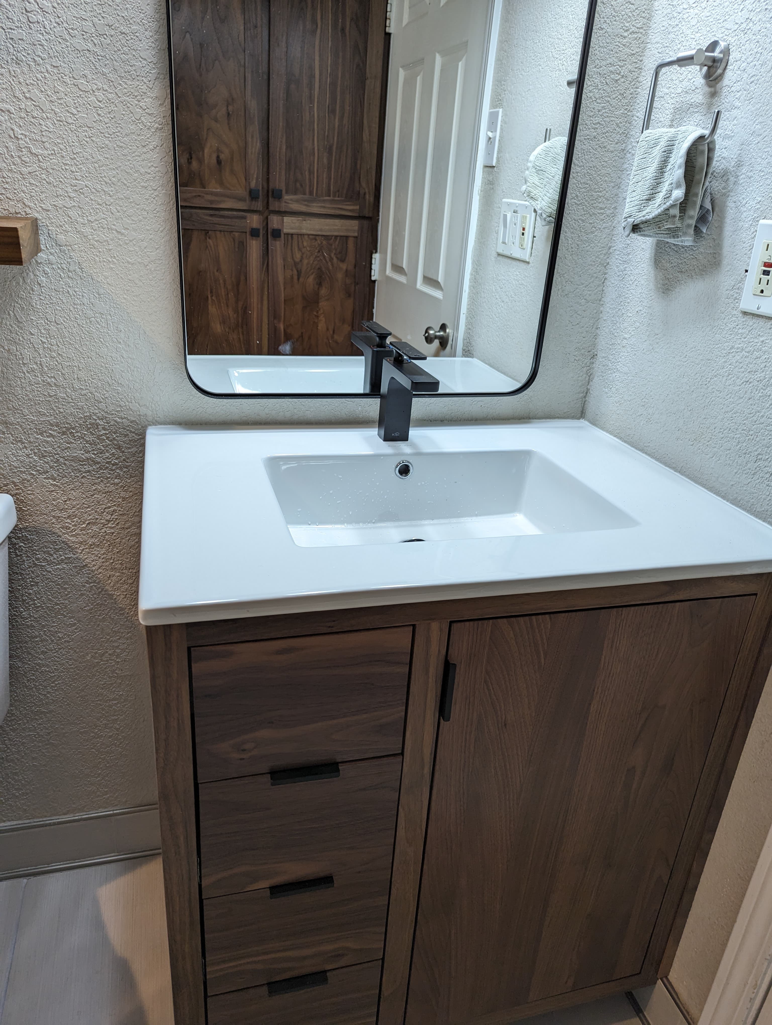 Professional bathroom remodel project featuring custom bathroom vanity walnut white countertop
