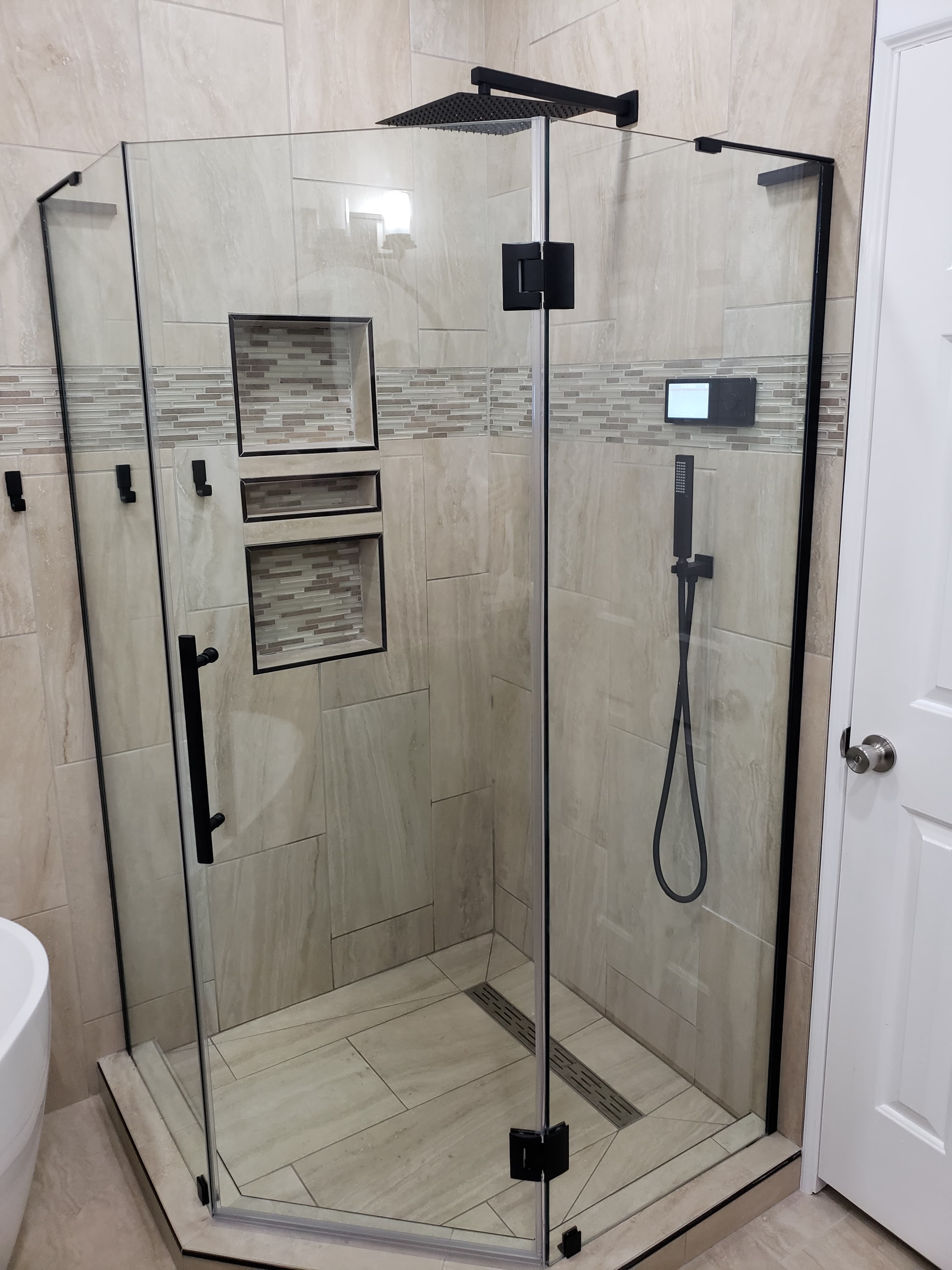 Professional bathroom remodel project featuring custom shower large format tile glass doors