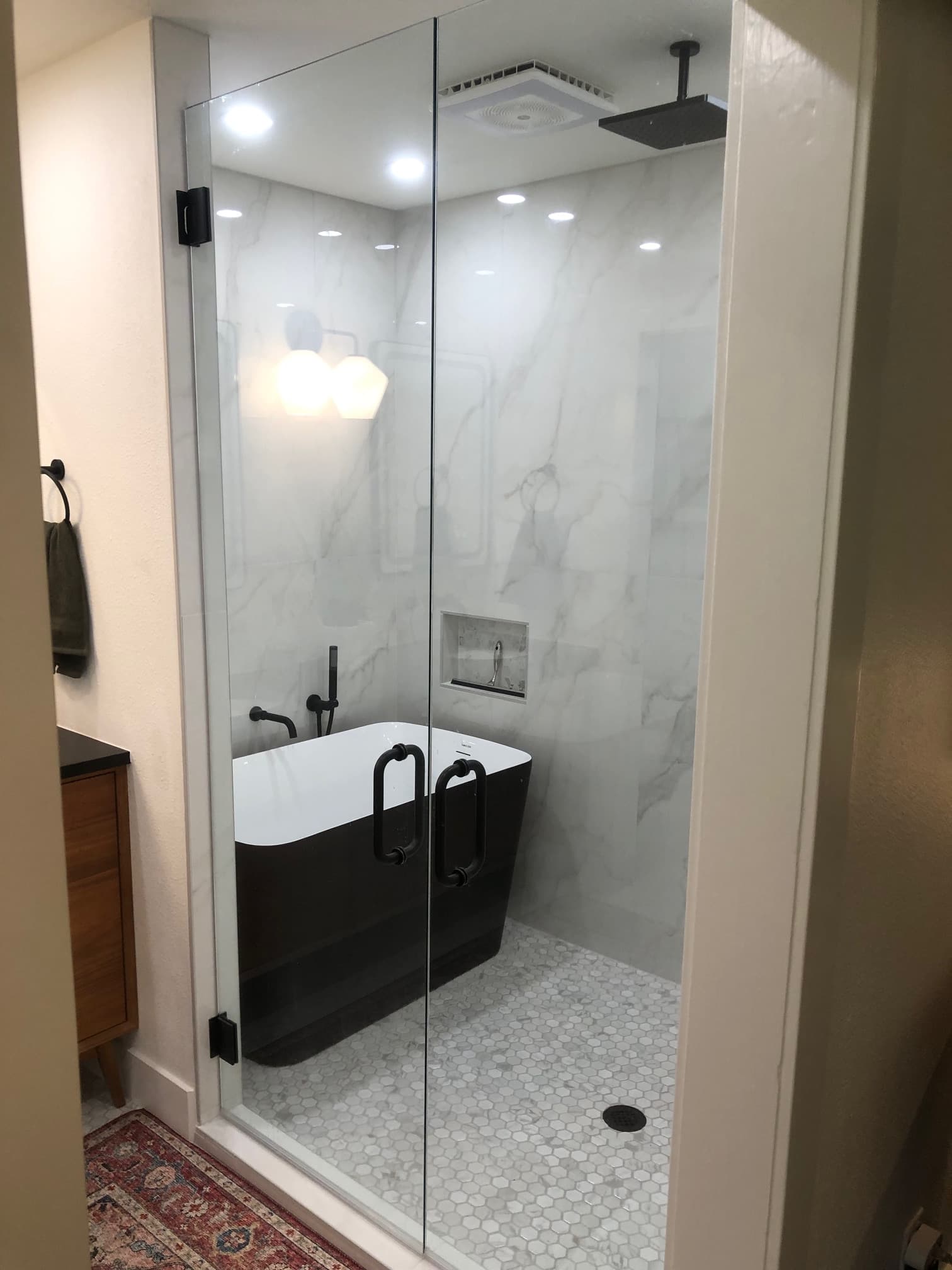 Professional bathroom remodel project featuring luxury bathroom marble walls black fixtures
