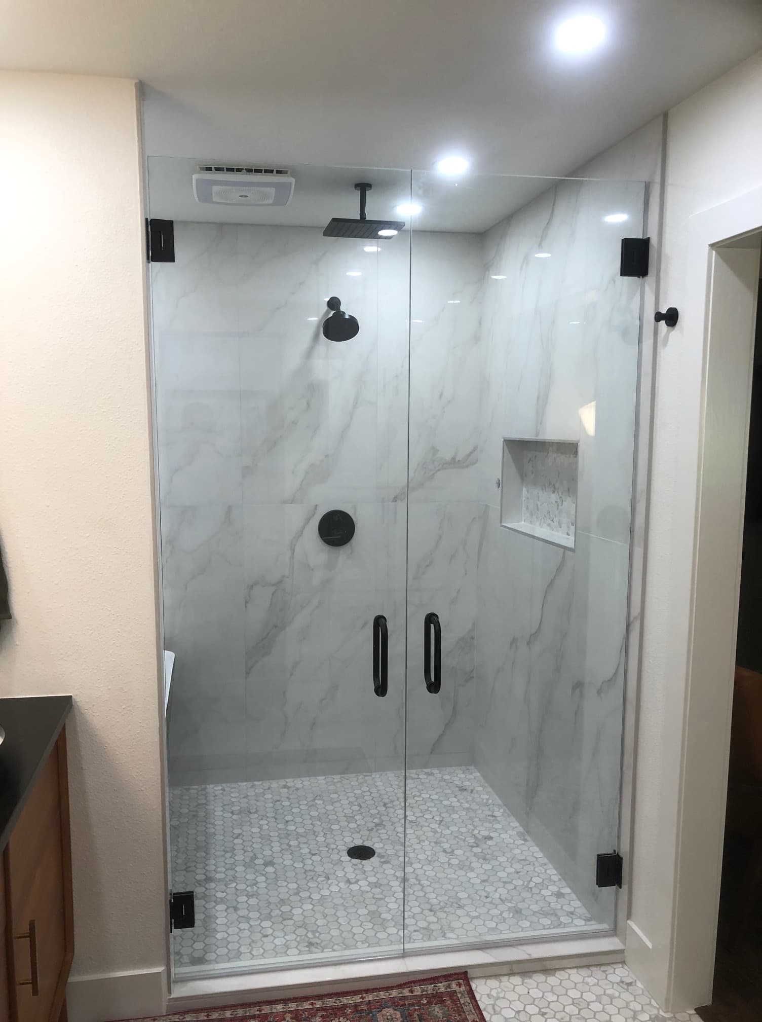 Luxury Bathroom Porcelain Tile Shower With Glass Doors in New Braunfels, TX