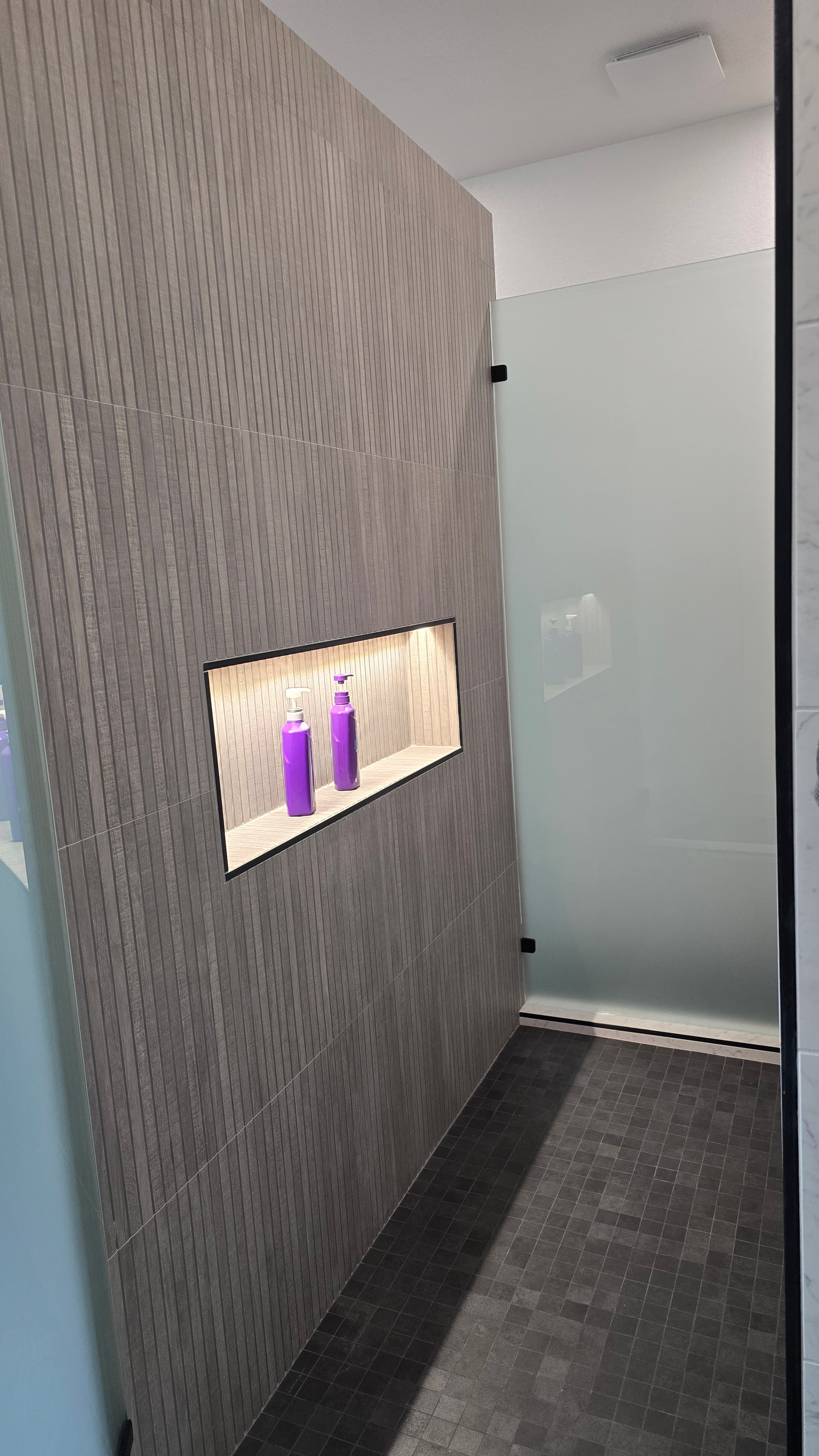 Professional bathroom remodel project featuring luxury bathroom renovation large format tiles