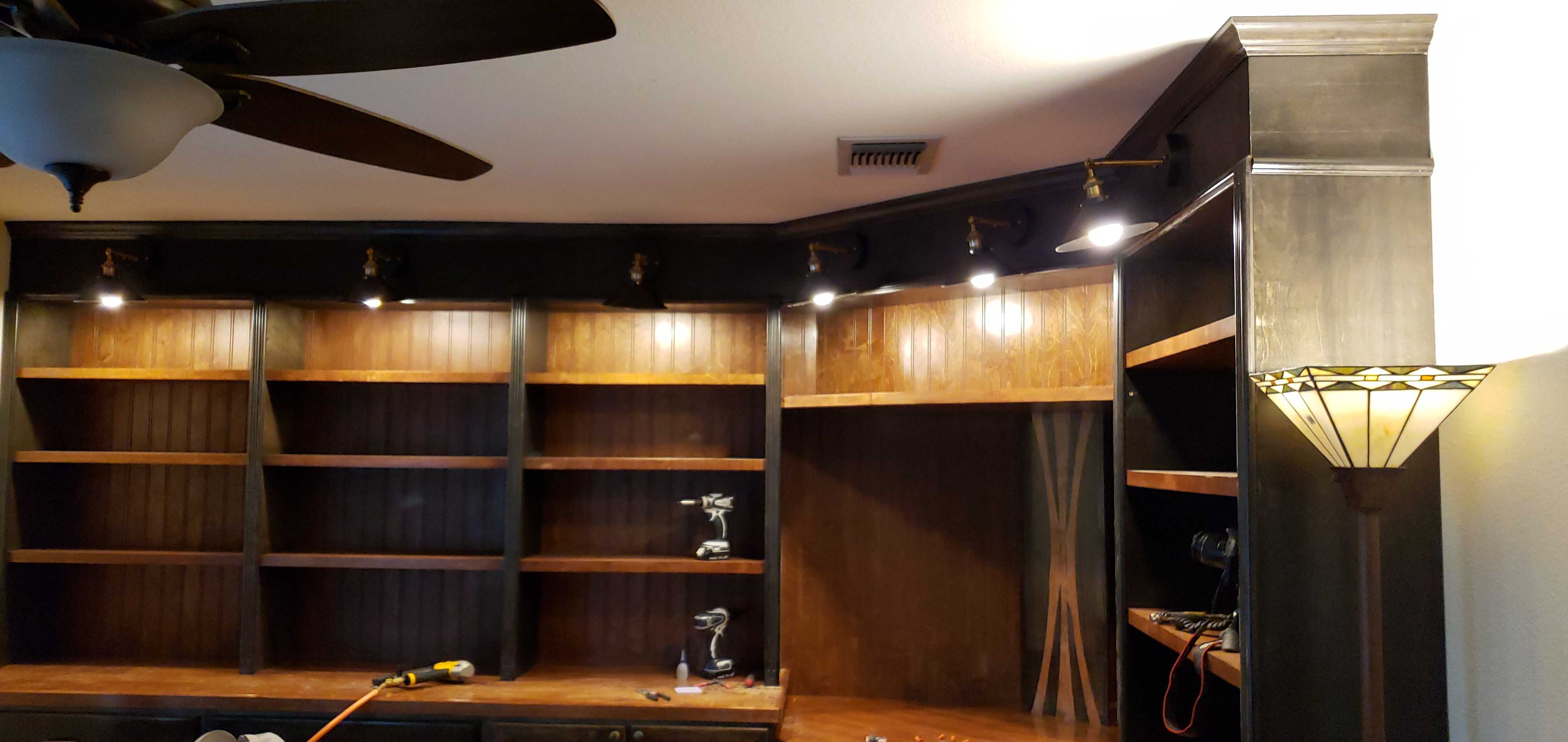 Custom entertainment center with wood shelving and track lighting - San Antonio TX