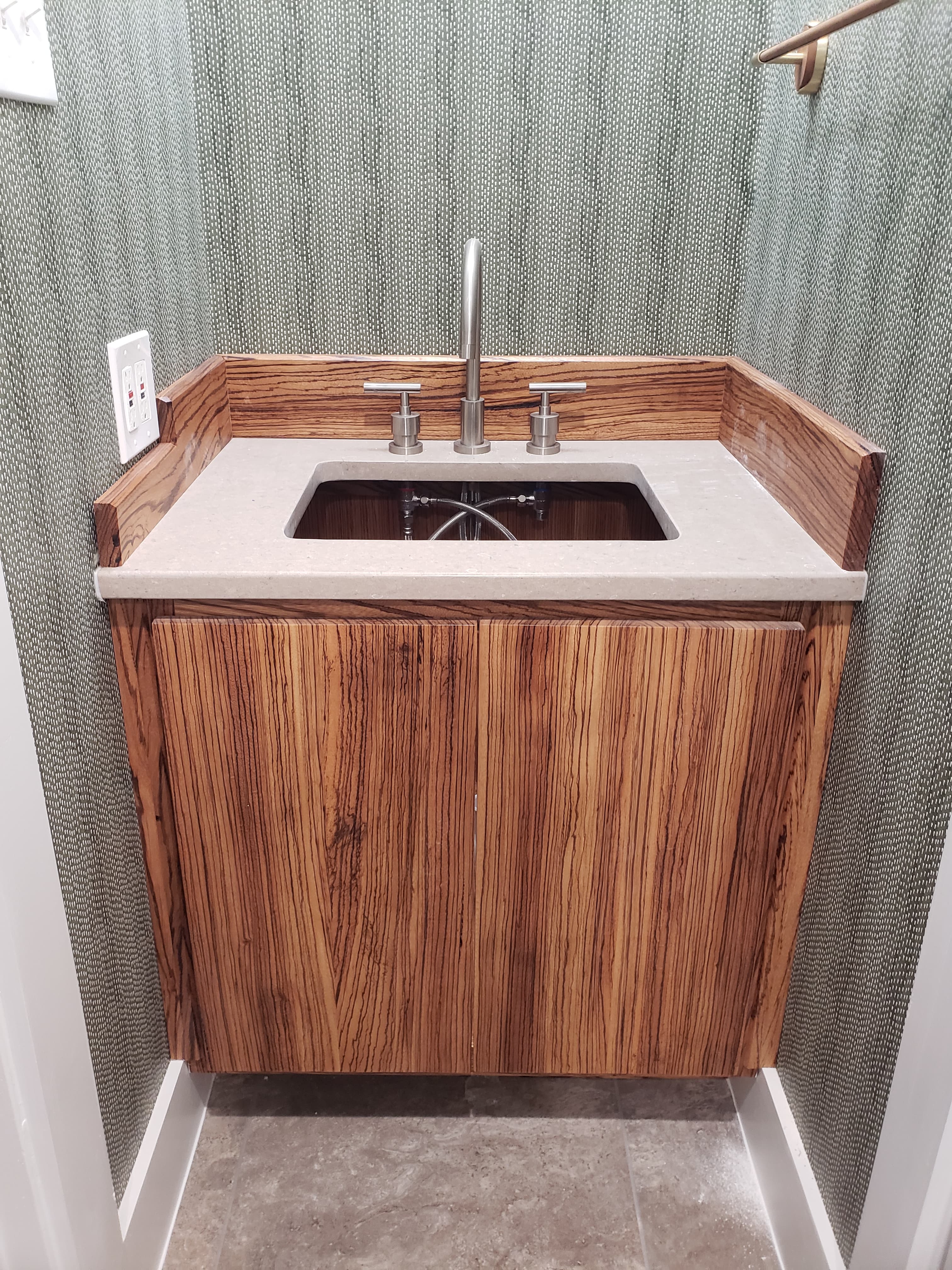 Custom wall-mounted vanity with zebrawood veneer finish - San Antonio TX