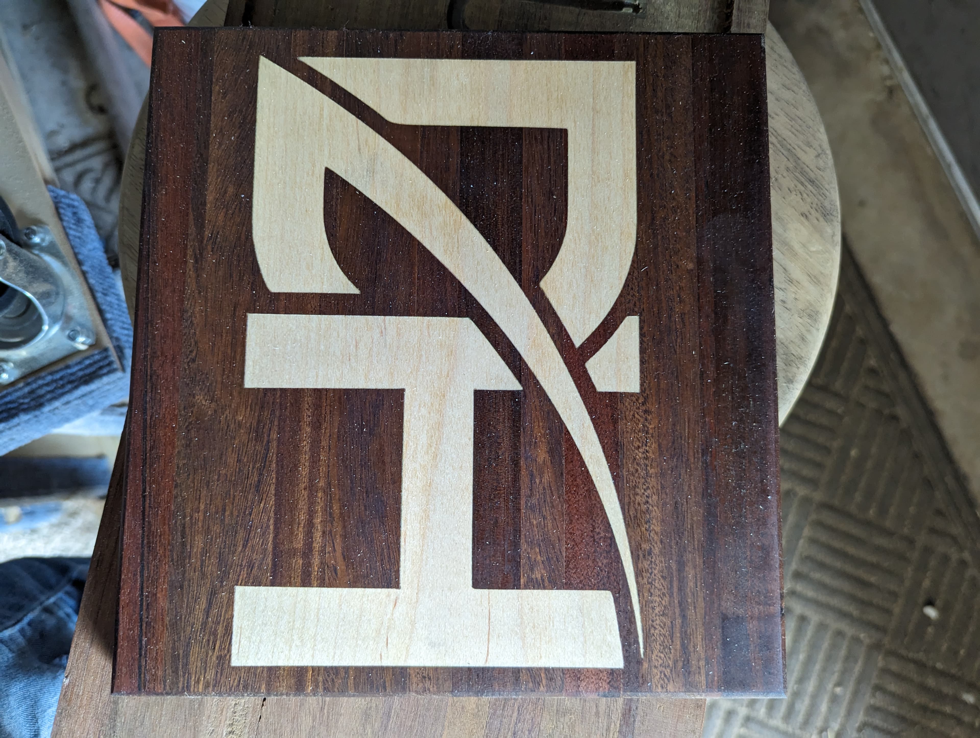 Custom CNC inlay logo design in walnut wood - San Antonio carpentry