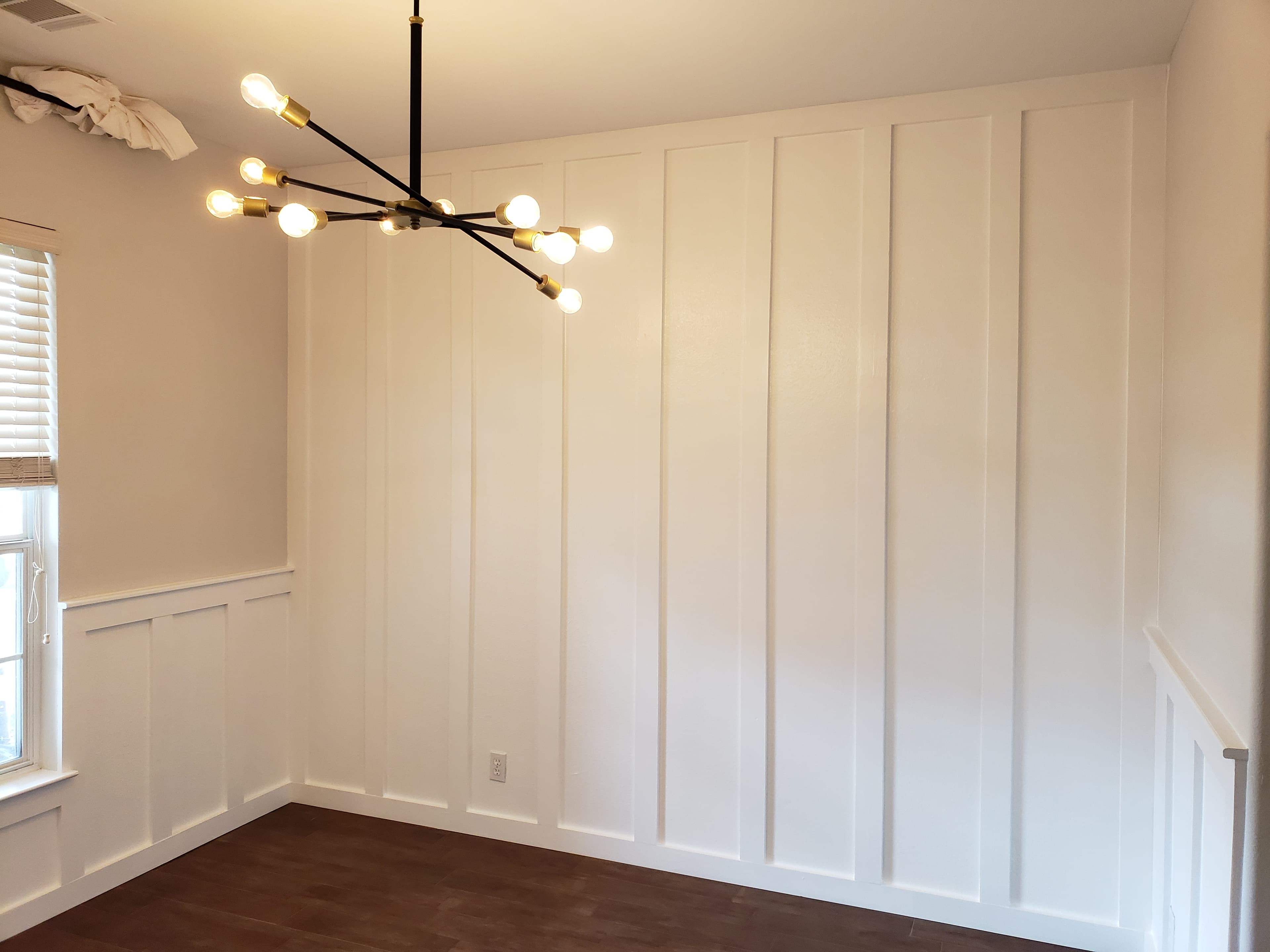 Custom board and batten accent wall with chandelier - San Antonio carpentry