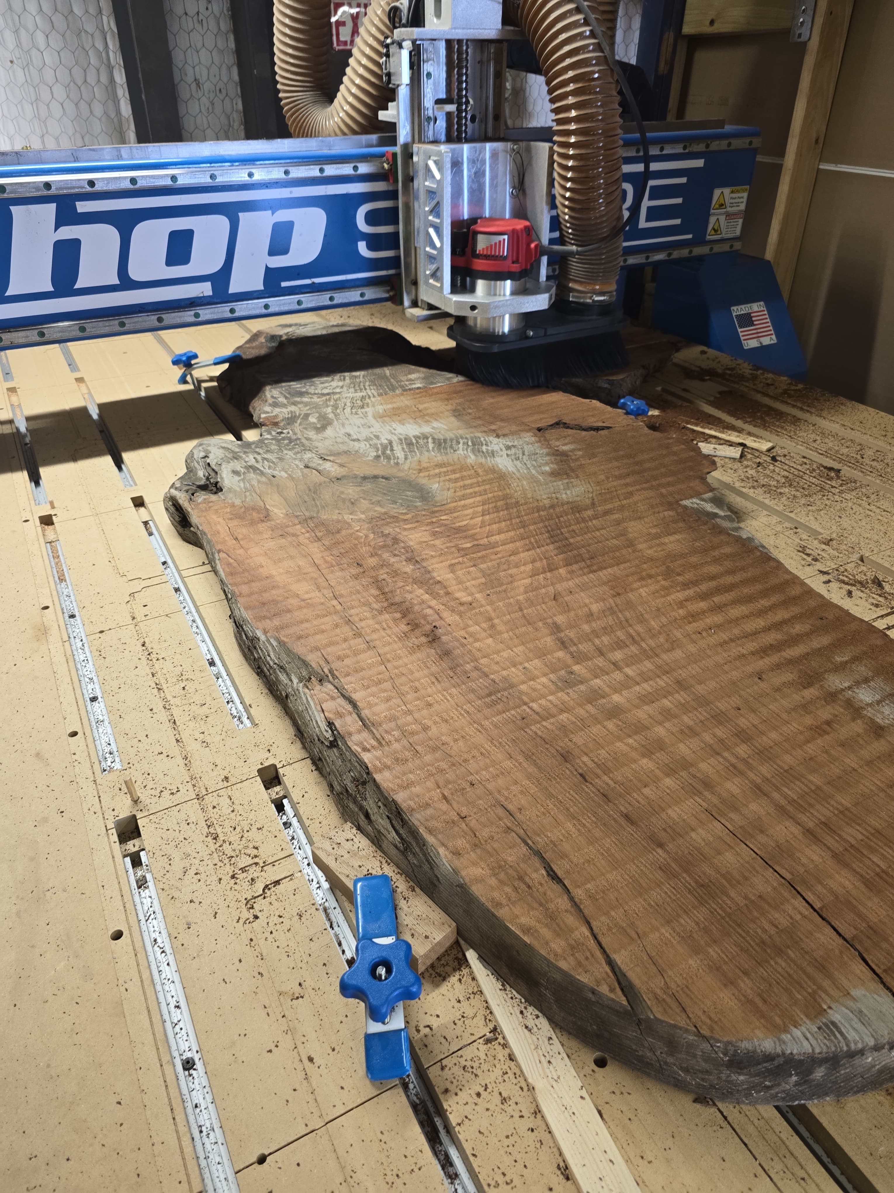 Custom live-edge wood slab preparation in workshop - San Antonio carpentry