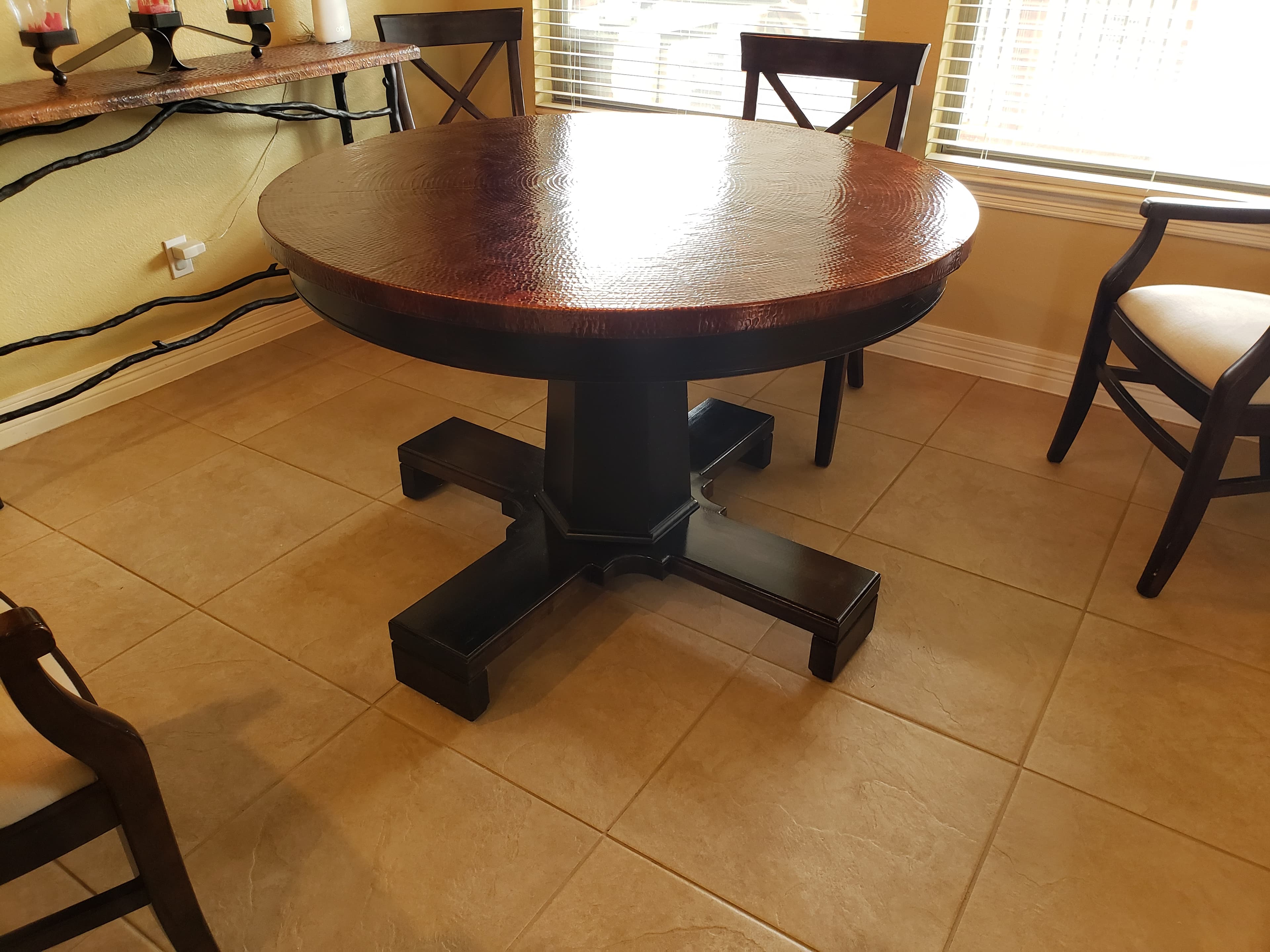 Custom round dining table with copper top and pedestal base - San Antonio carpentry