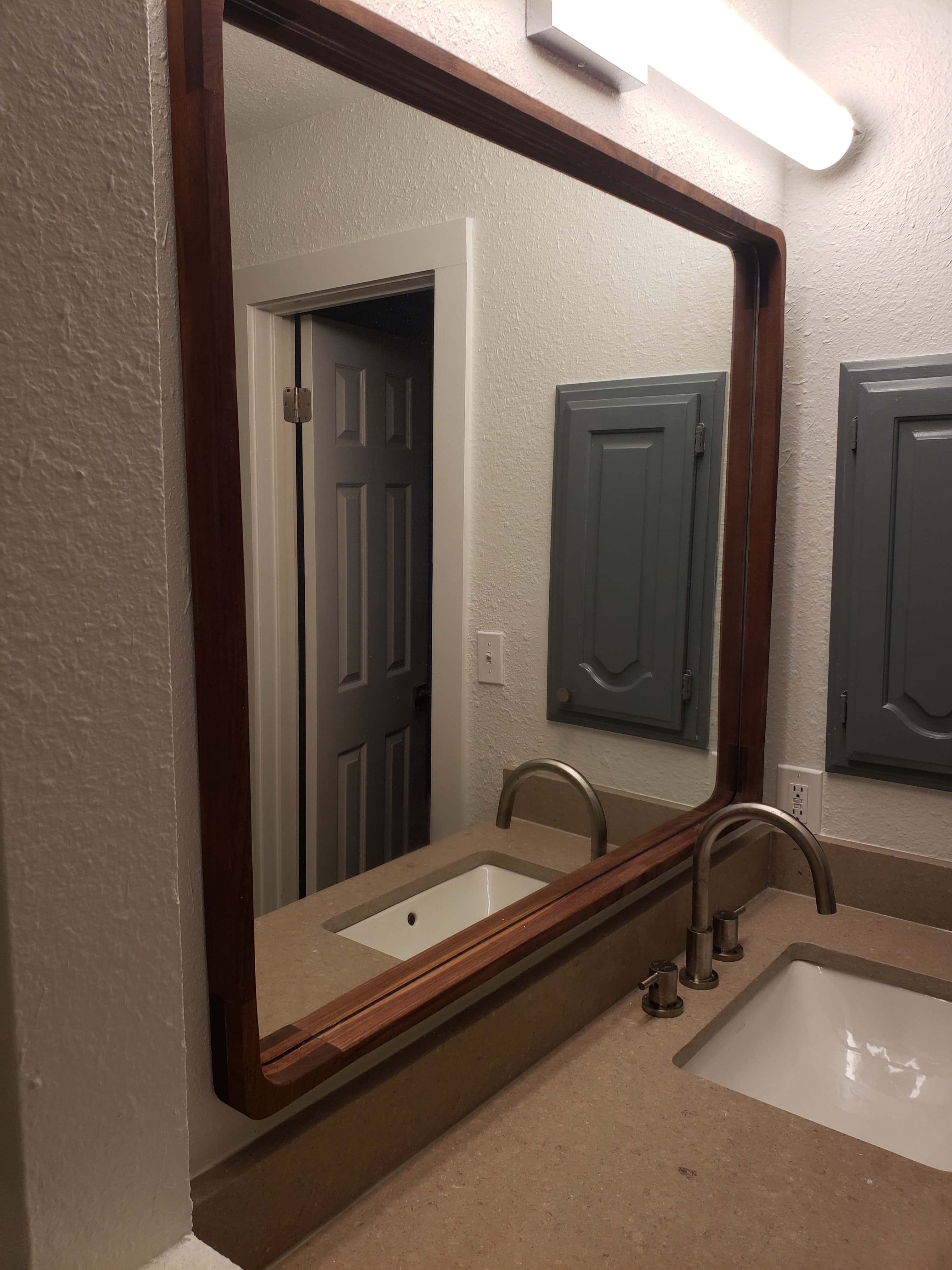 Custom walnut mirror frame with hand-finished edges - San Antonio carpentry