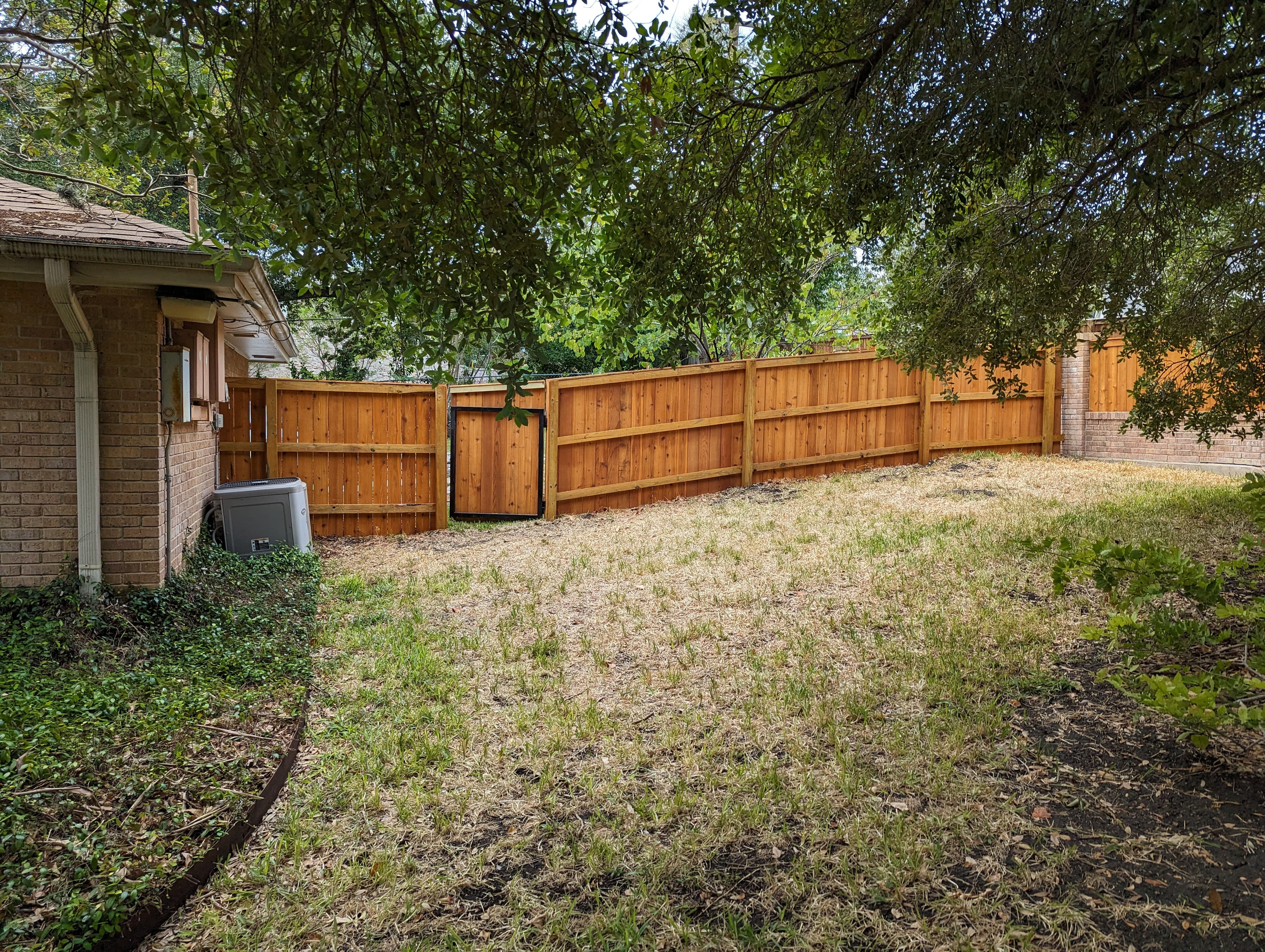 Professional fencing project featuring cedar fence gate hardware detail black