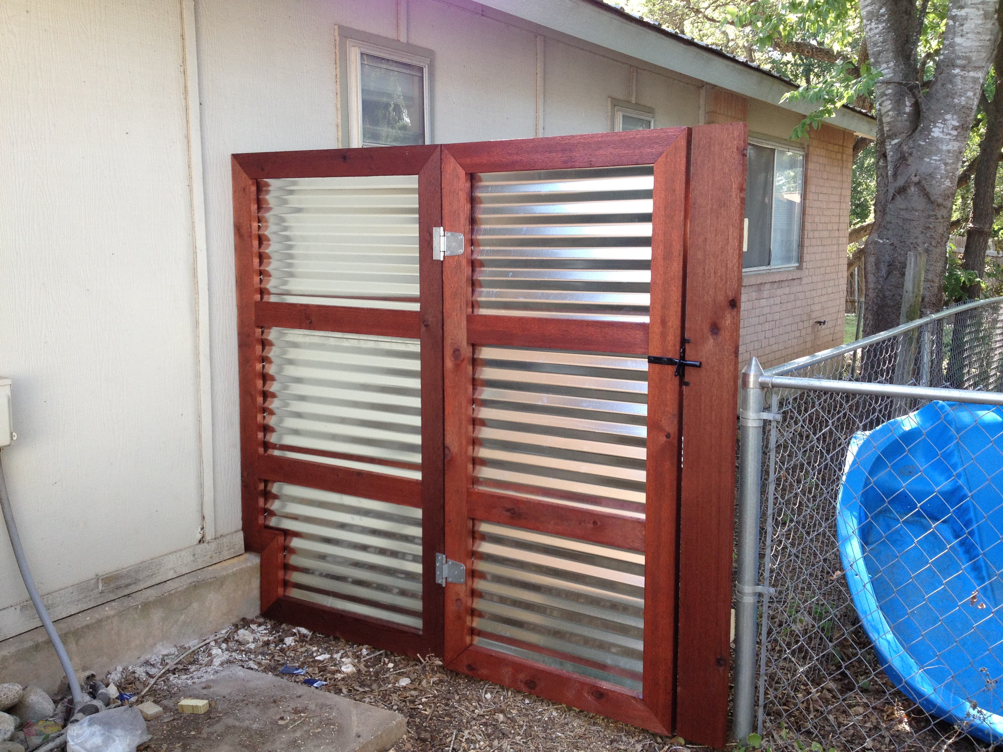 Professional fencing project featuring corrugated metal wood frame gate cedar