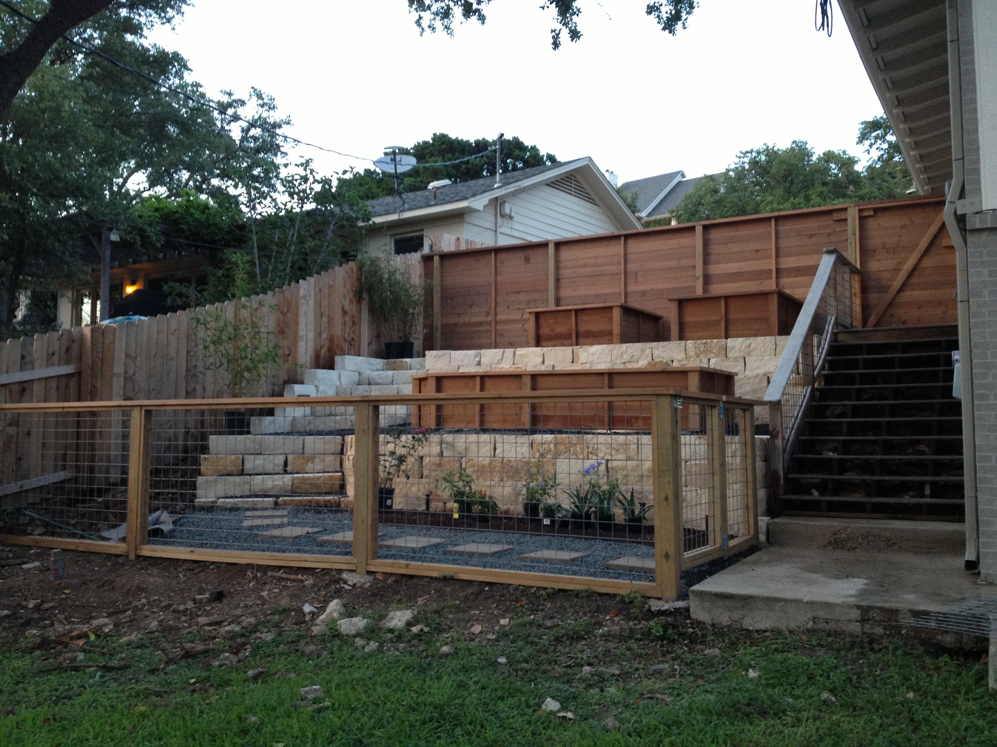Professional fencing project featuring fenced garden retaining wall planters
