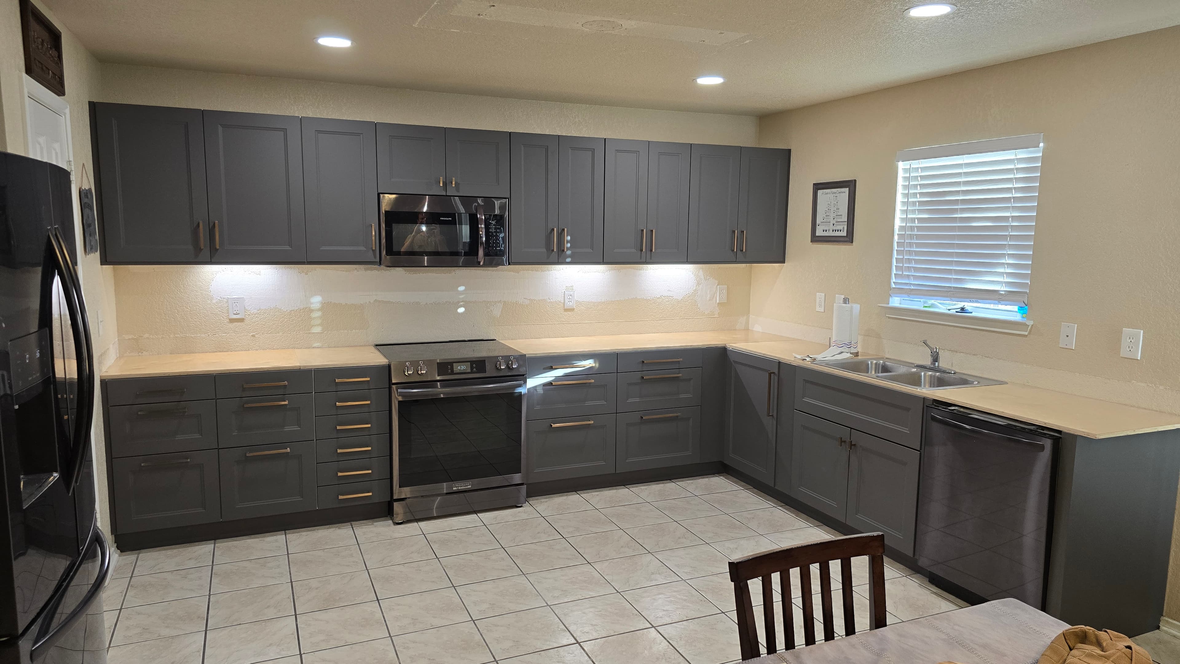 Professional kitchen remodel project featuring custom kitchen cabinet installation progress