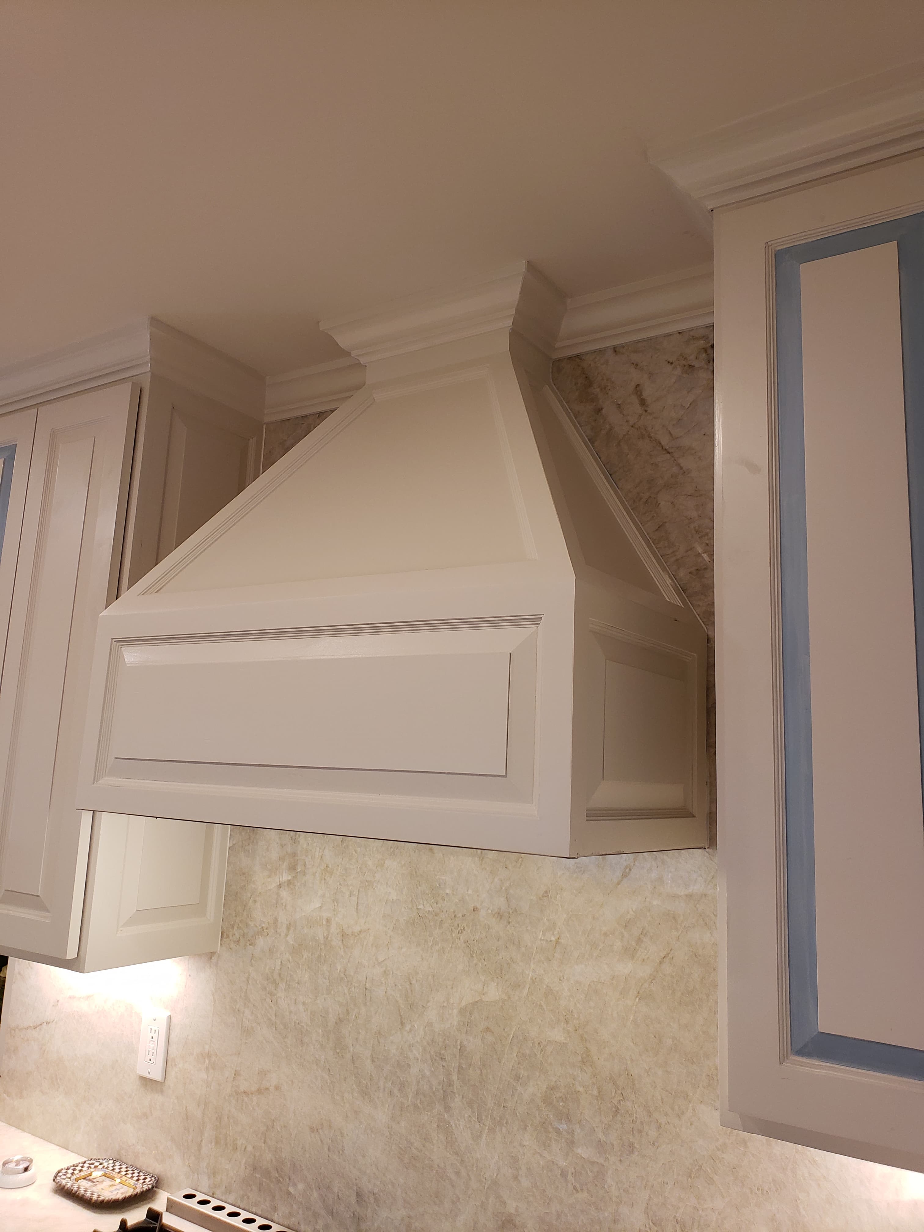 Professional kitchen remodel project featuring custom kitchen vent hood