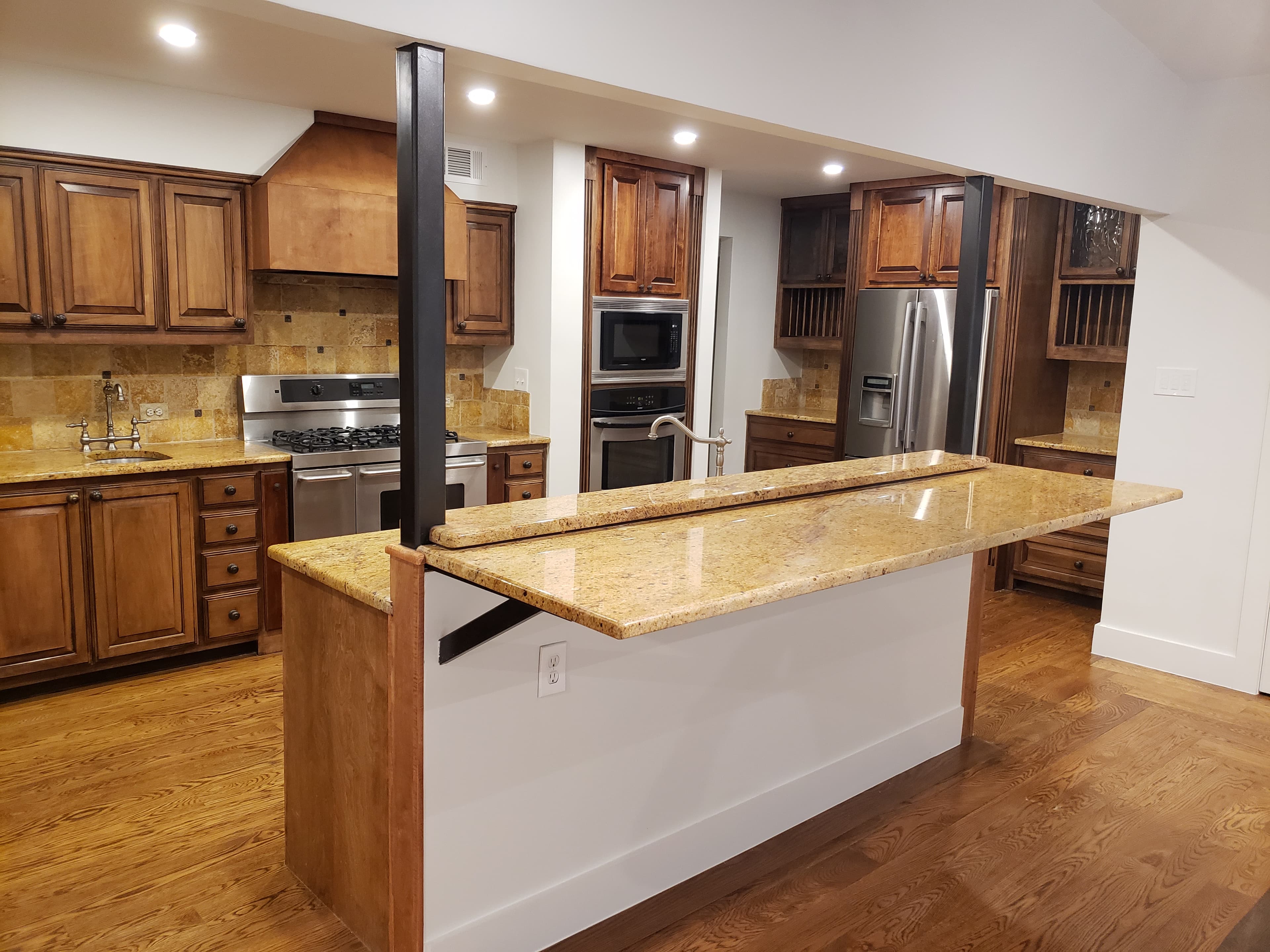 Professional kitchen remodel project featuring traditional kitchen granite countertops copper backsplash
