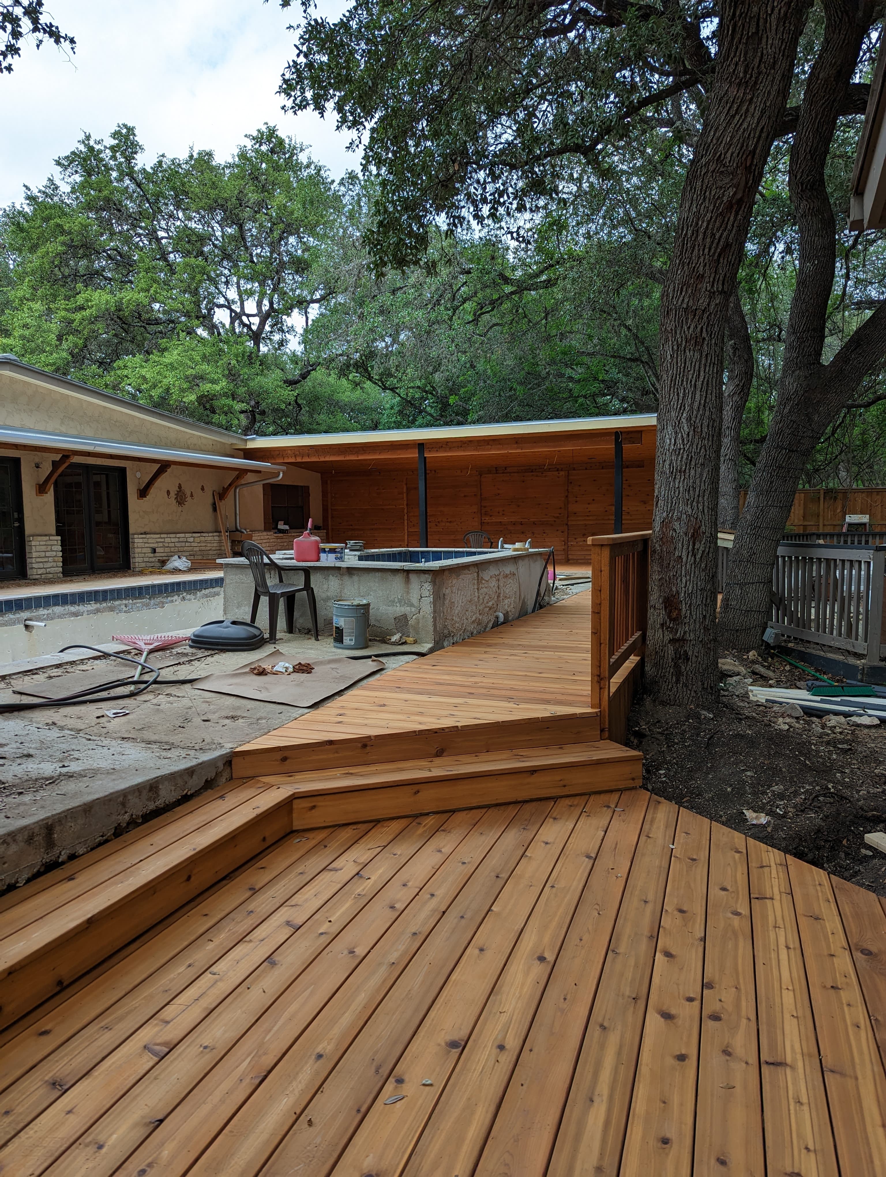 Professional outdoor living project featuring cedar deck pool construction progress