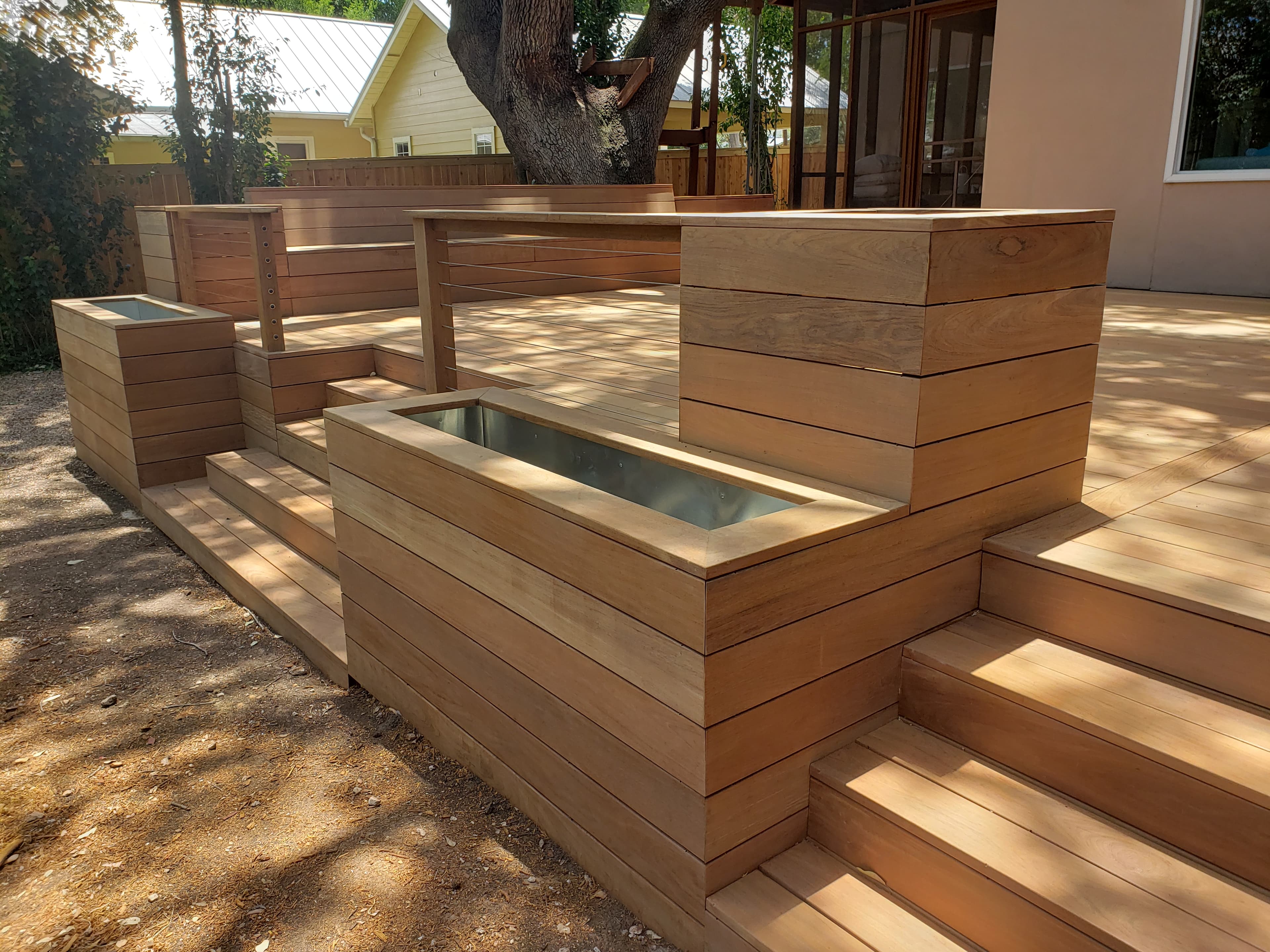 Professional outdoor living project featuring cedar deck with built in spa planters