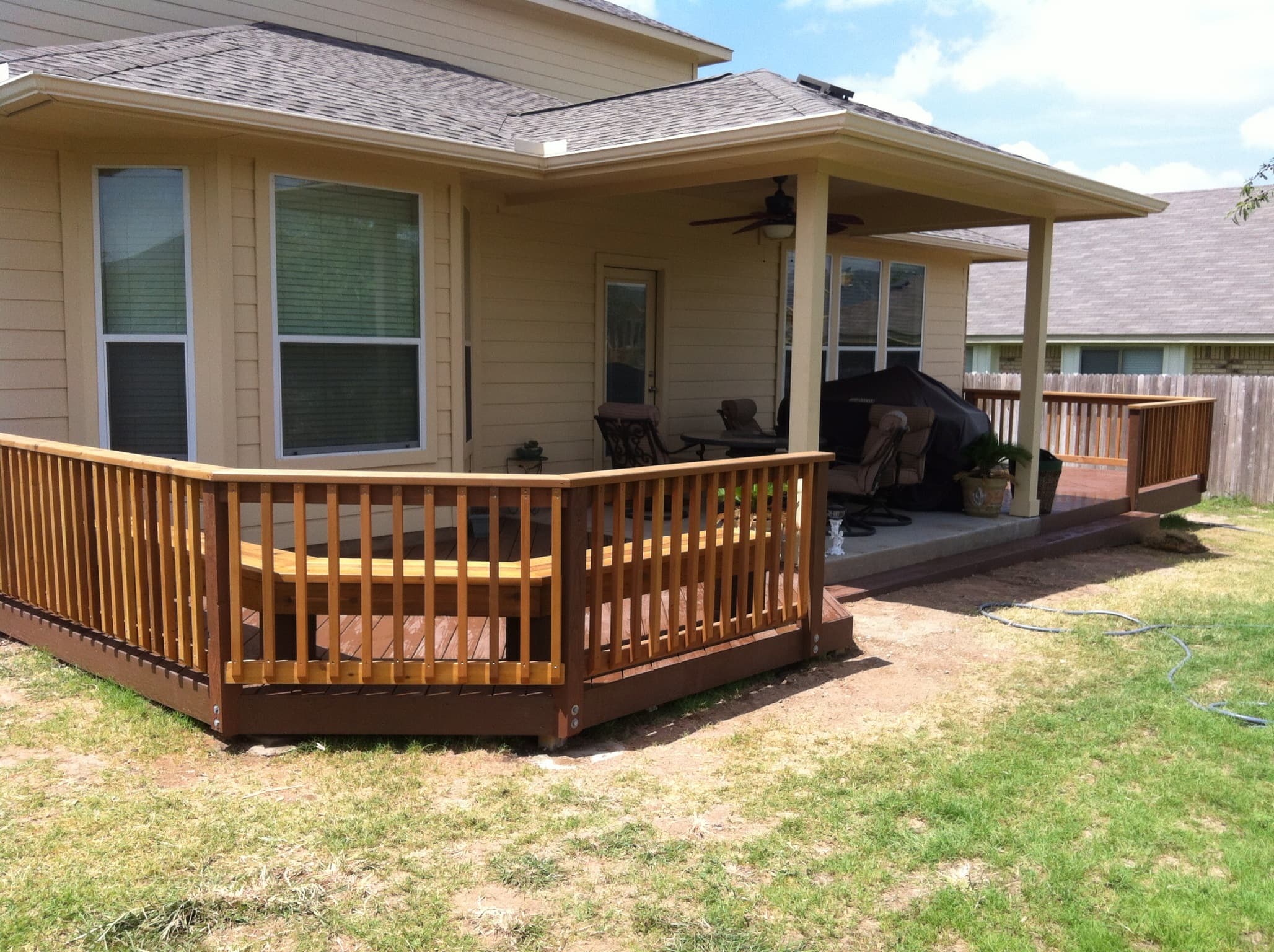 Professional outdoor living project featuring cedar deck with traditional railings