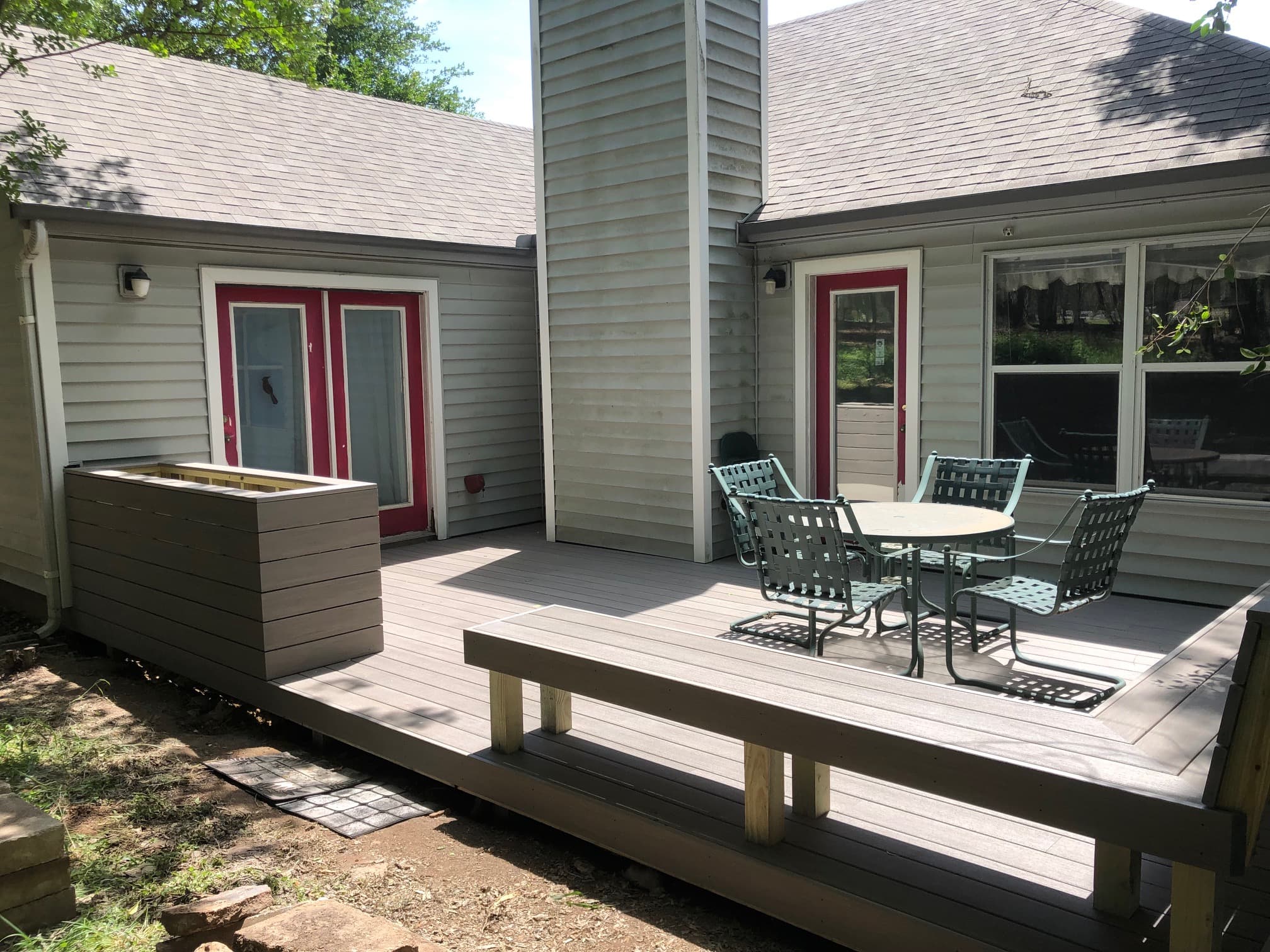 Professional outdoor living project featuring composite deck with planter box