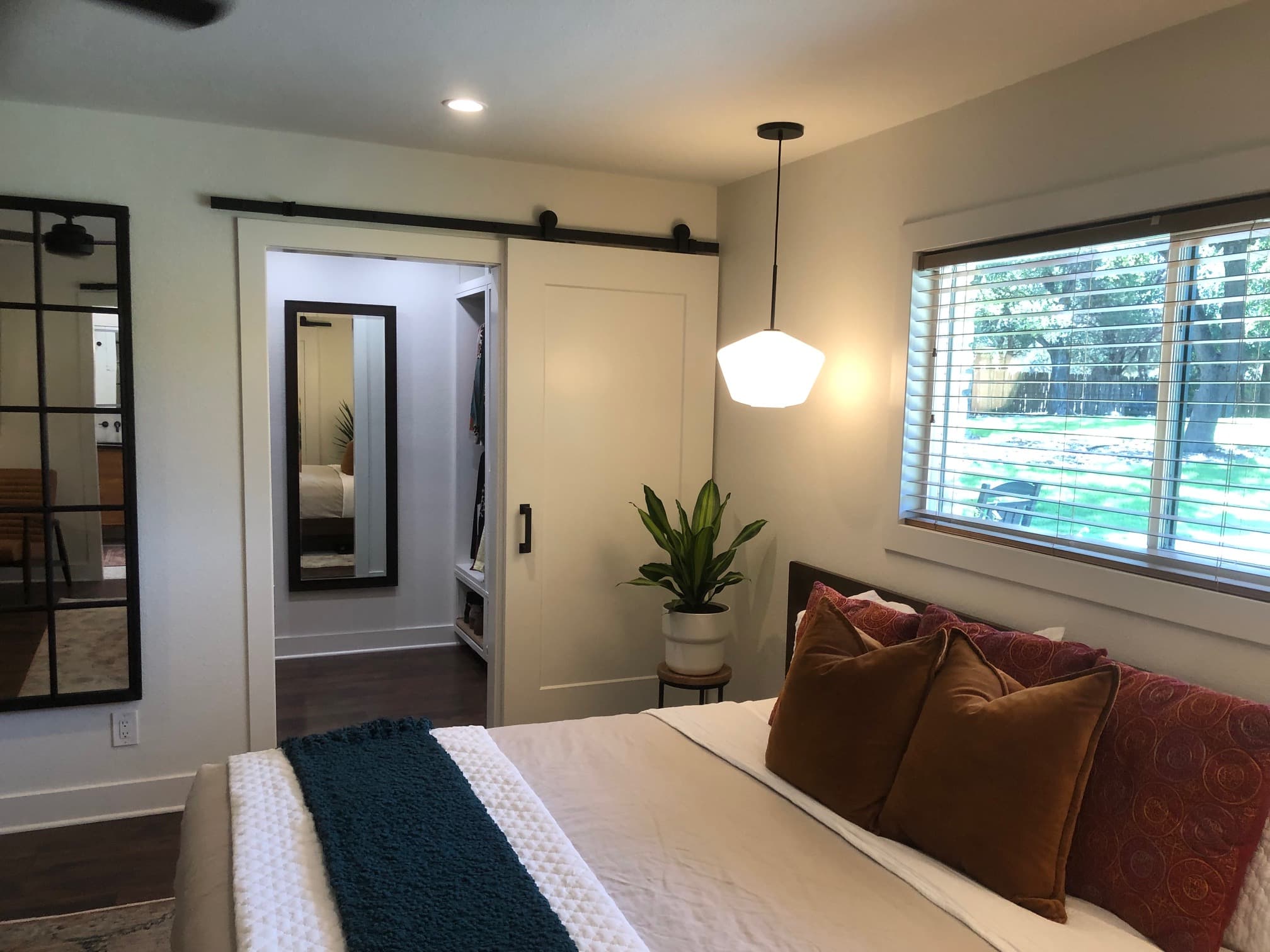 Professional whole home remodel project featuring bedroom barn door pendant light design