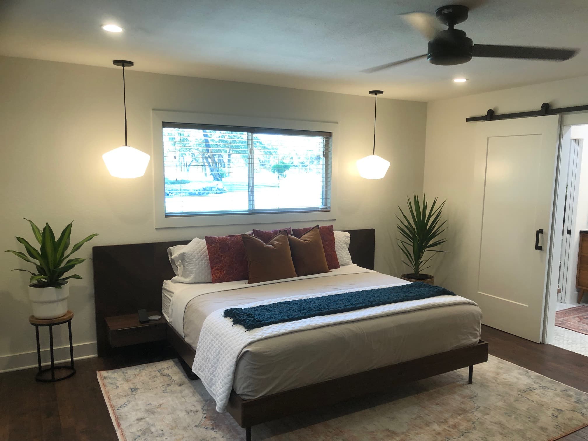Professional whole home remodel project featuring modern bedroom pendant lighting barn door