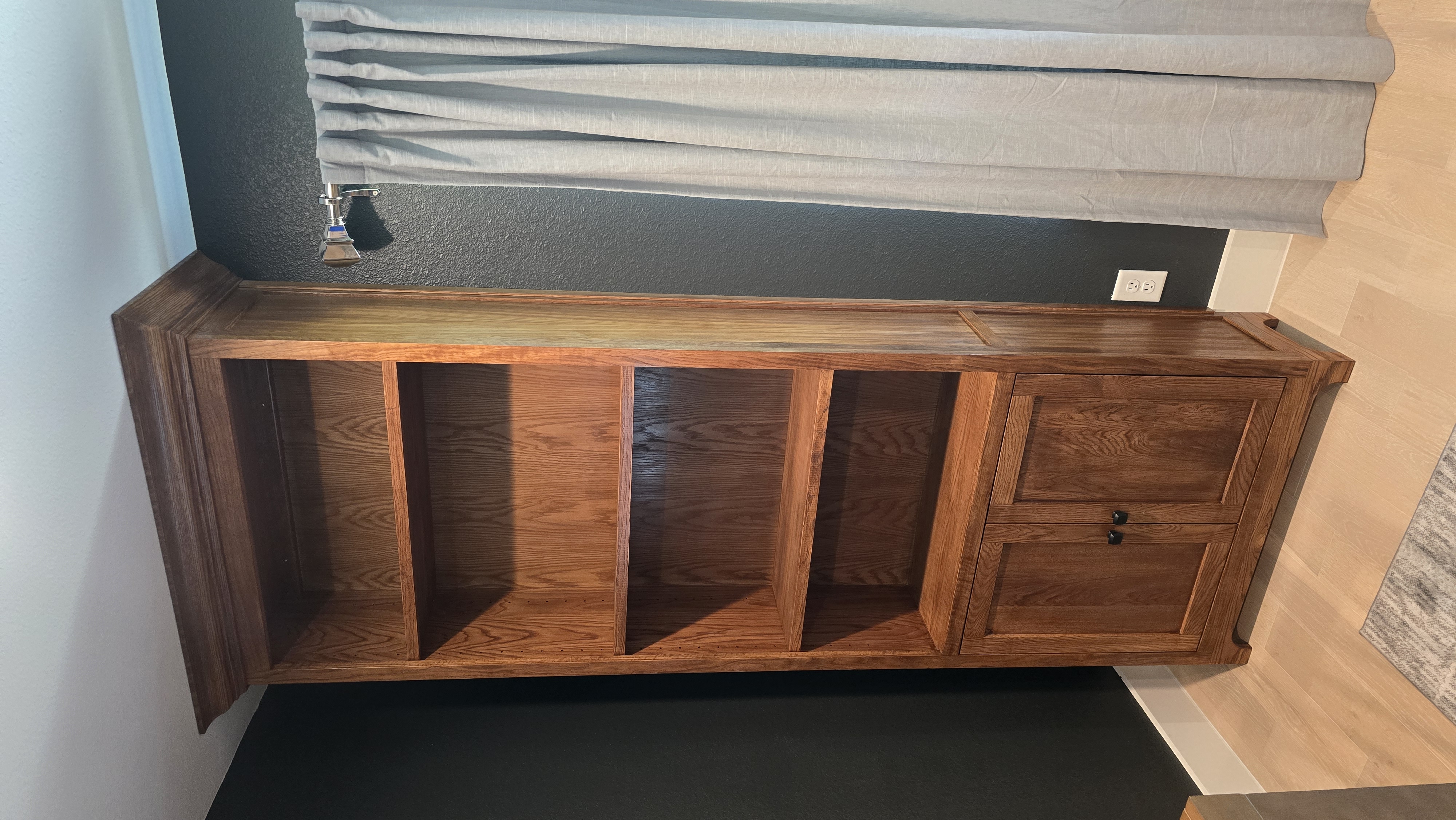 Custom entertainment center with dark walnut built-in shelving and integrated storage.